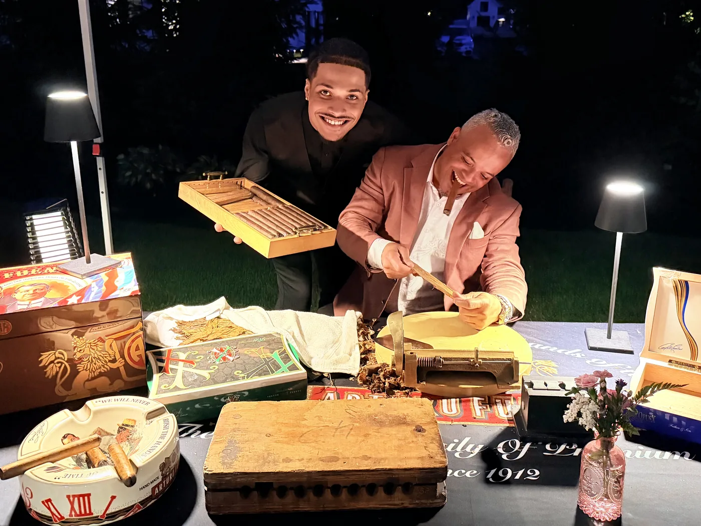 Franklin at the board with his assistant beside him, both working the table after dark