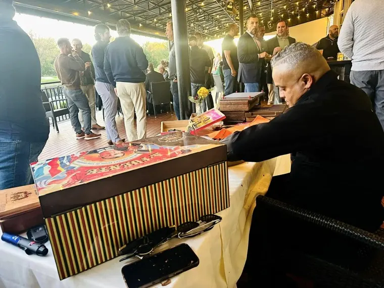 His rolling table set up at an event, guests behind