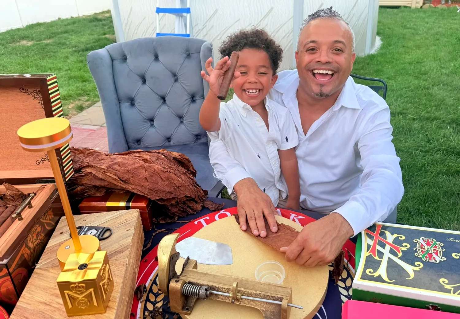 Franklin laughing with a small child beside his rolling table